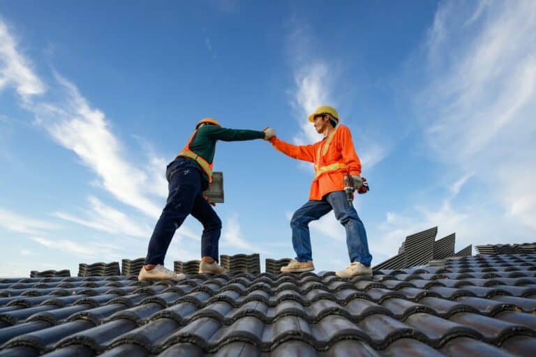 Two roofers working at height